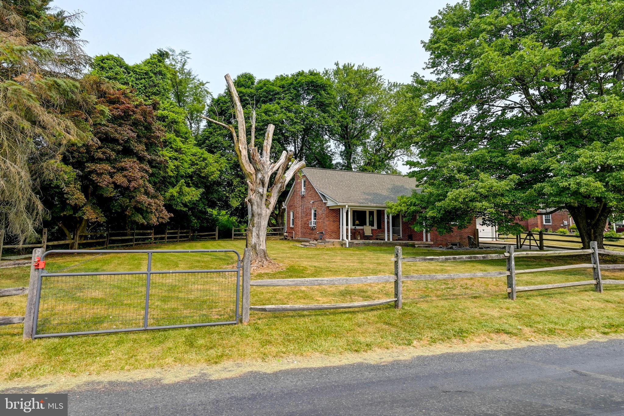 5371 Long Corner Road White Hall, MD 21161 - Photo 2 of 30 a view of a swimming pool with a lawn chairs under an umbrella