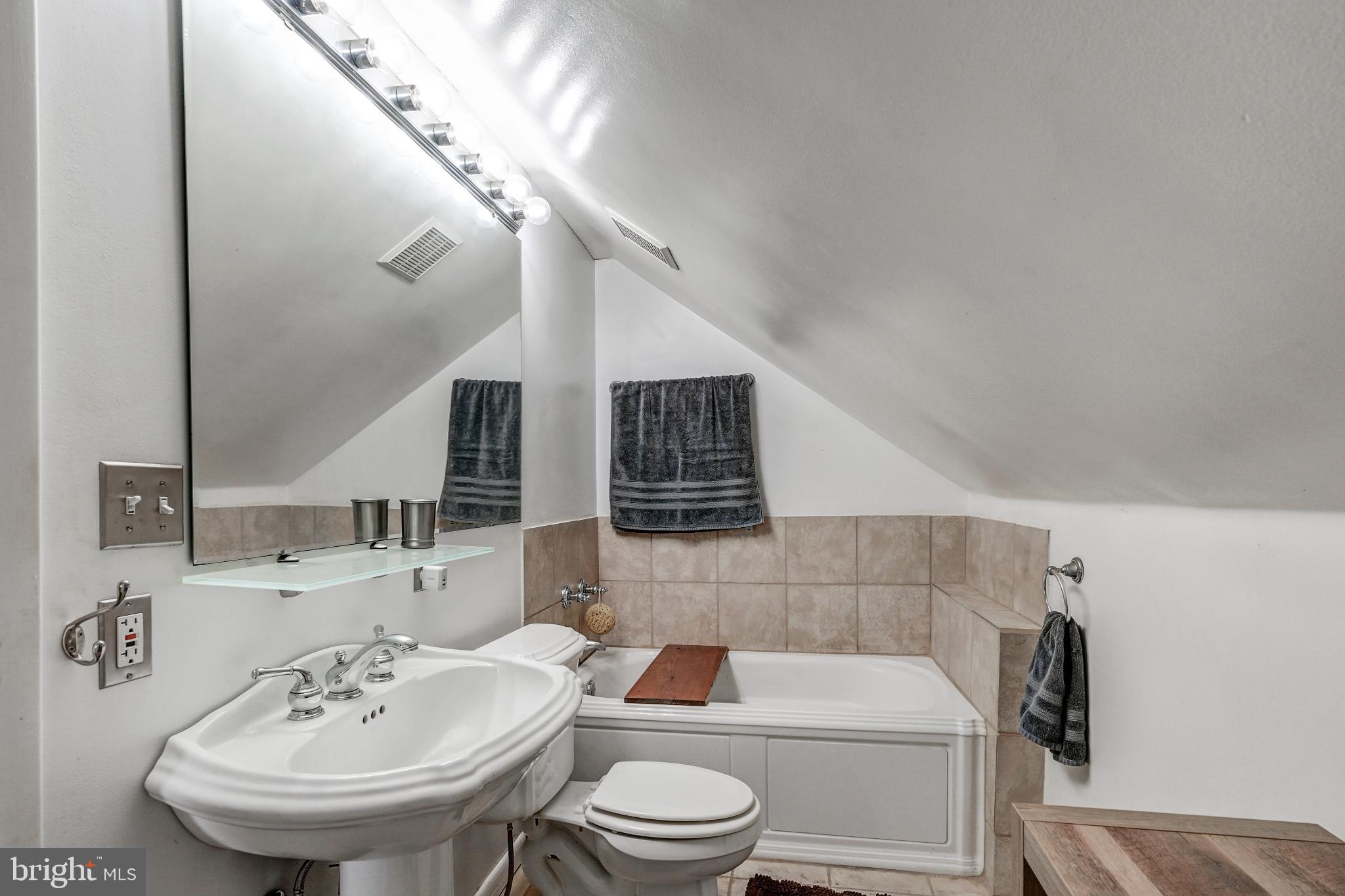 5371 Long Corner Road White Hall, MD 21161 - Photo 21 of 30 a bathroom with a toilet a sink and a mirror