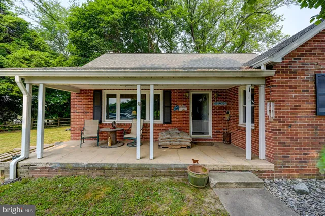 a view of a house with backyard porch and sitting area