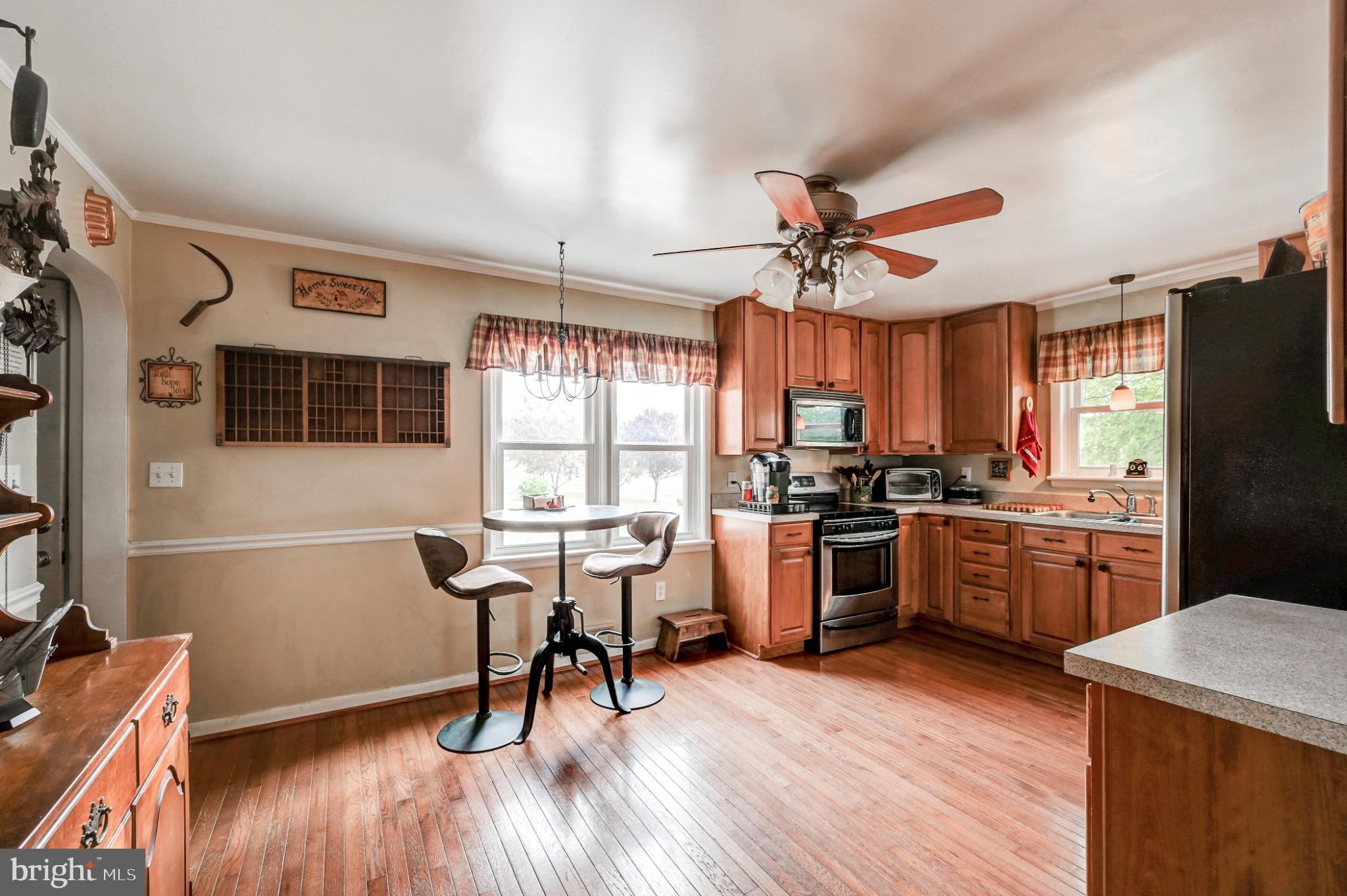 5371 Long Corner Road White Hall, MD 21161 - Photo 10 of 30 a kitchen with a table chairs refrigerator and cabinets