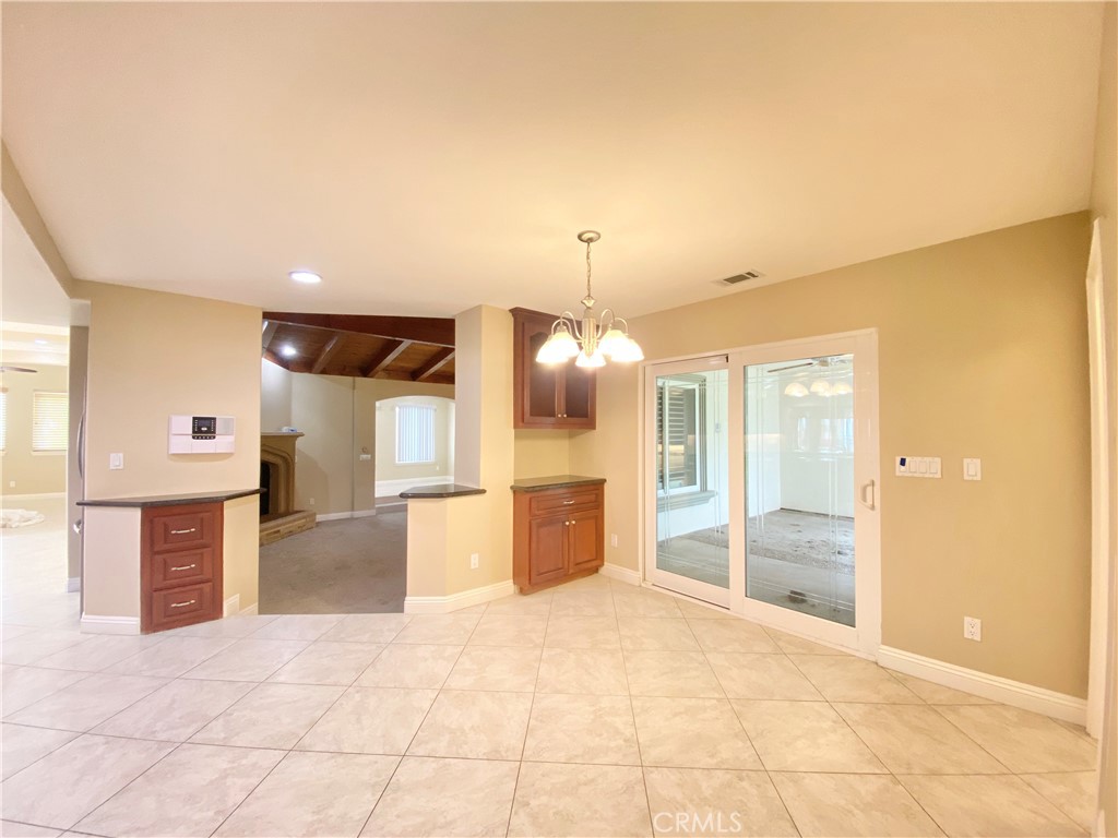 14670 Gilman Springs Road Moreno Valley, CA 92555 - Photo 14 of 50 a large room with a large window and chandelier