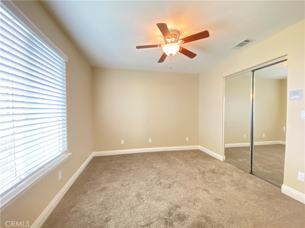 14670 Gilman Springs Road Moreno Valley, CA 92555 - Photo 29 of 50 an empty room with window and ceiling fan