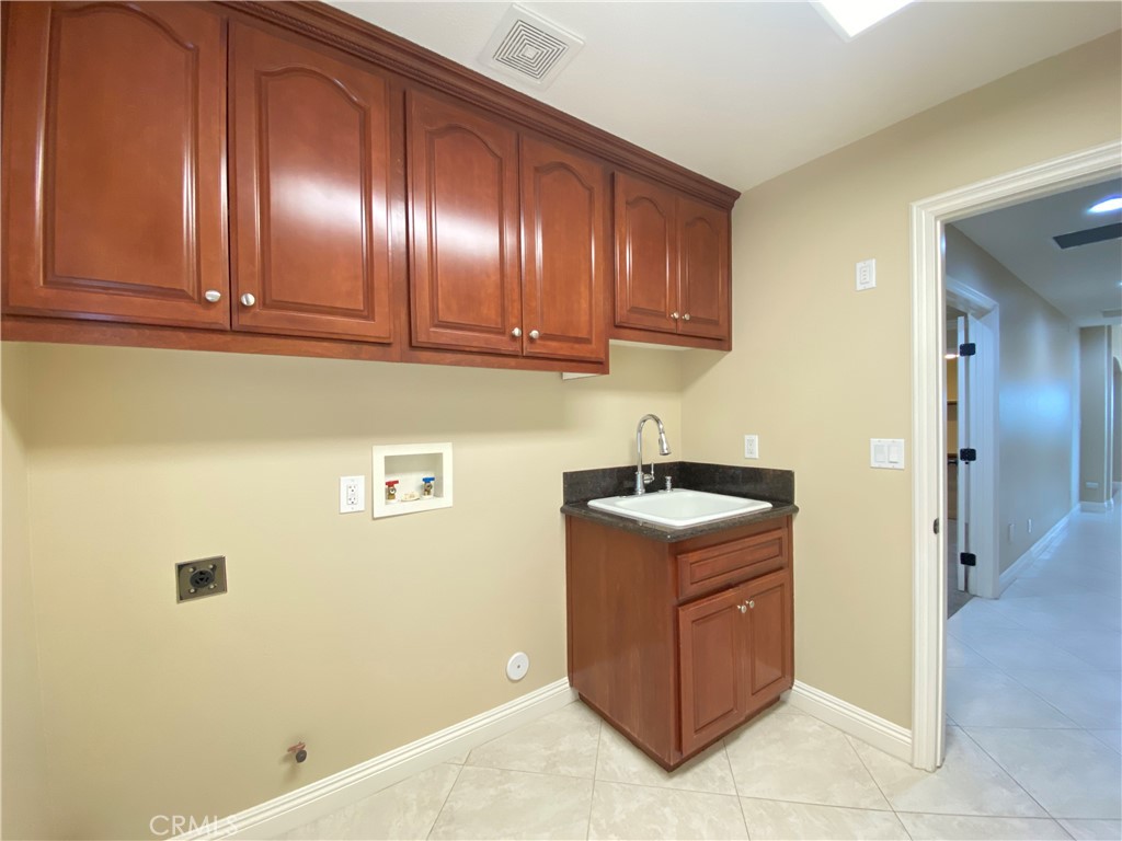 14670 Gilman Springs Road Moreno Valley, CA 92555 - Photo 32 of 50 a room with a cabinets and washer