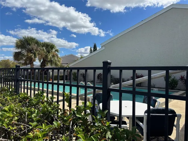 a view of a chairs and table in the balcony