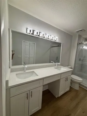 a bathroom with a double vanity sink and mirror