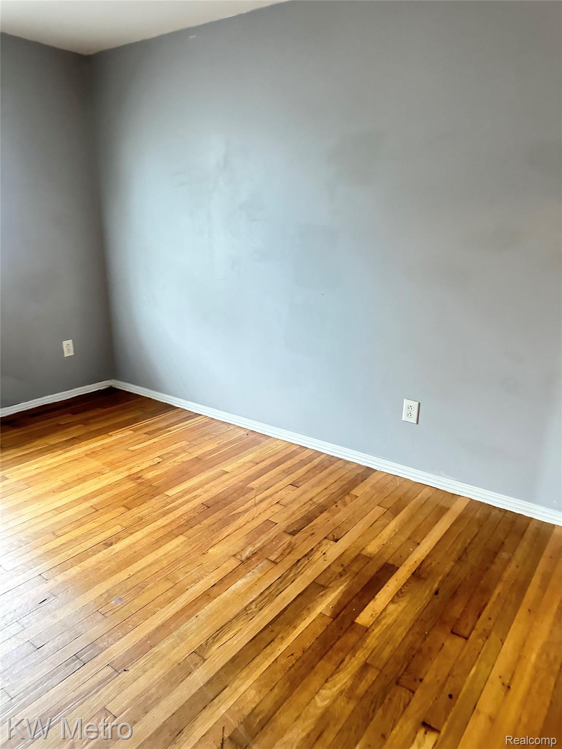 78 Orchard Street River Rouge, MI 48218 - Photo 7 of 8 Hardwood flooring, light gray wall finish, and white trim