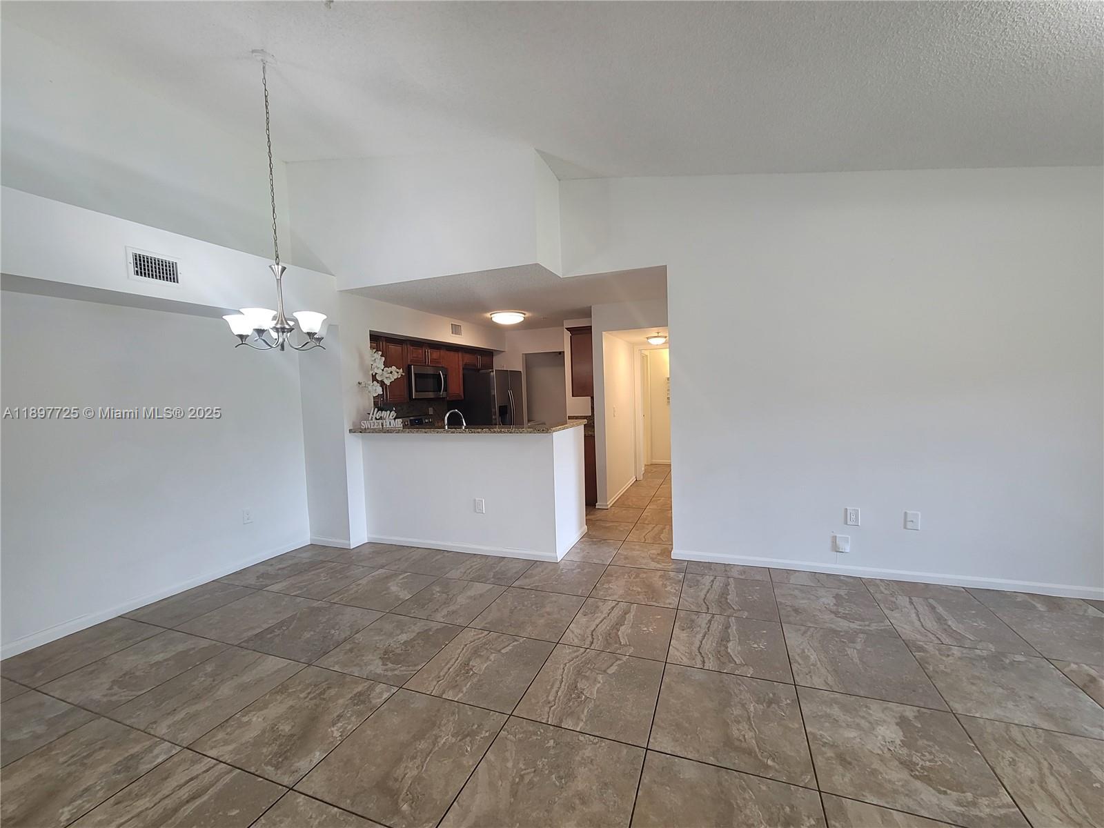 2133 Renaissance Boulevard, Unit 306 Miramar, FL 33025 - Photo 13 of 41 a view of a kitchen with a sink and dishwasher cabinets