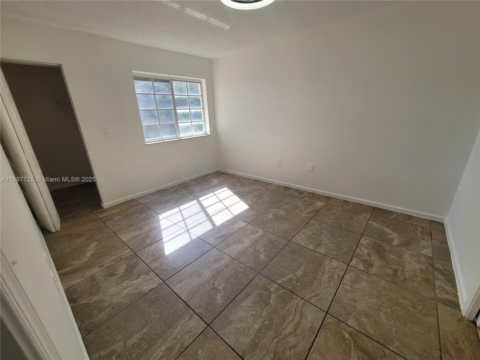 2133 Renaissance Boulevard, Unit 306 Miramar, FL 33025 - Photo 19 of 41 a view of an empty room and window