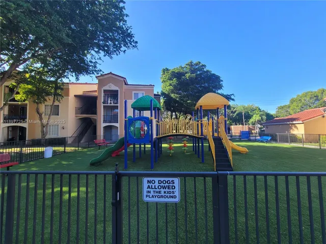 a view of a brick house with a yard and plants