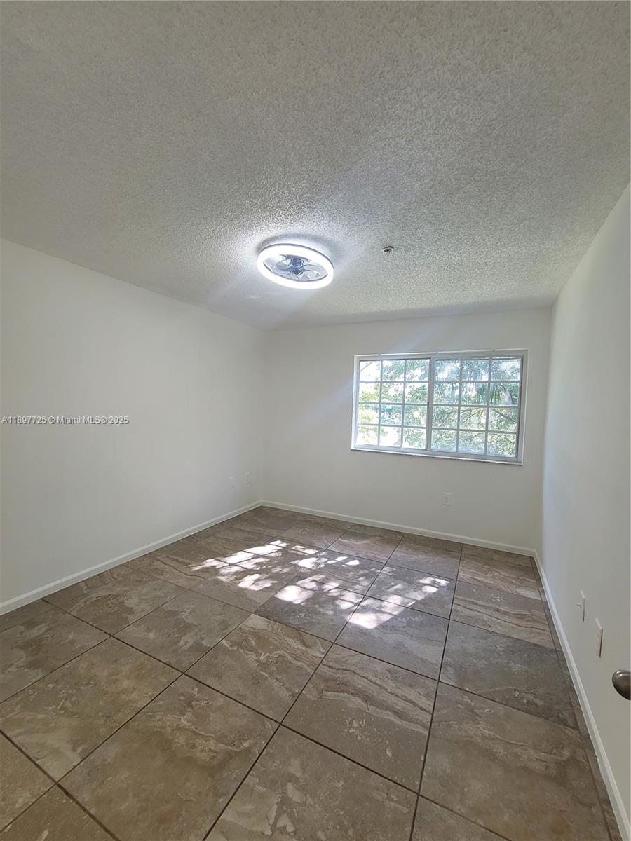 2133 Renaissance Boulevard, Unit 306 Miramar, FL 33025 - Photo 26 of 41 an empty room with windows