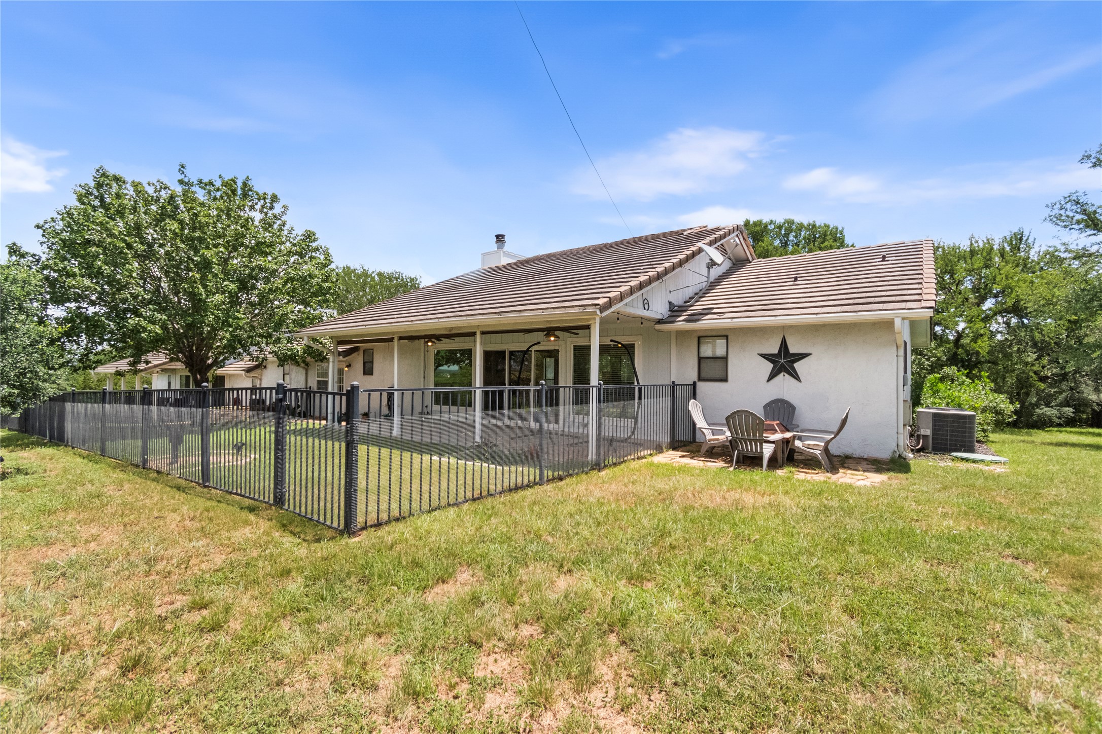 210 Teeoff, Unit B Horseshoe Bay, TX 78657 - Photo 31 of 38 A private, fenced yard extends from a spacious covered patio, ideal for outdoor enjoyment.
