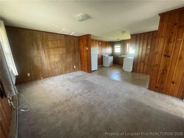 a view of a hall with wooden floor