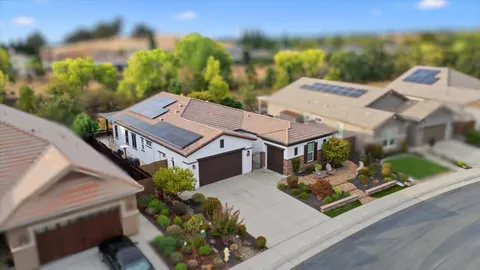 an aerial view of a house with garden space and street view