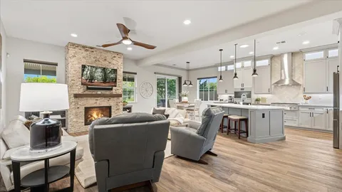 a living room with fireplace furniture and a flat screen tv