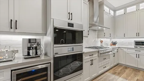 a kitchen with cabinets and stainless steel appliances