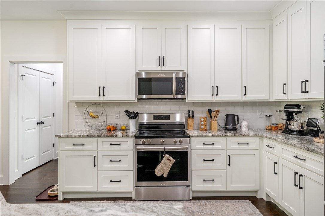 502 Canebrake Drive Anderson, SC 29621 - Photo 10 of 39 This bright kitchen features white cabinetry, granite countertops, and stainless steel appliances.