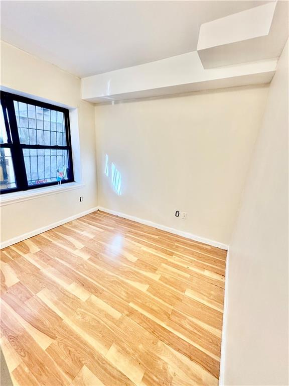 1476 67th Street, Unit 1 Brooklyn, NY 11219 - Photo 4 of 6 a view of empty room with wooden floor and fan