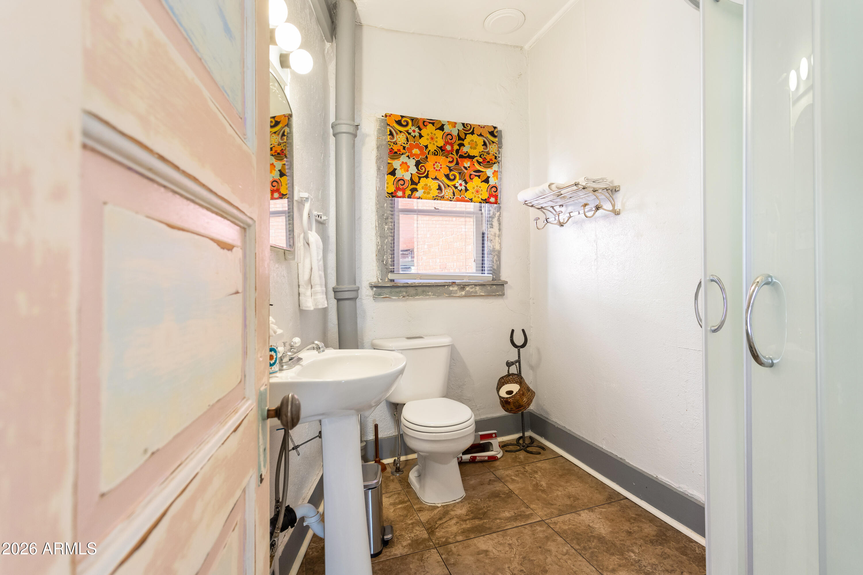 41 Main Street Bisbee, AZ 85603 - Photo 23 of 33 a bathroom with a sink a toilet and shower