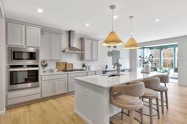 a kitchen with stainless steel appliances granite countertop a stove a sink and a refrigerator