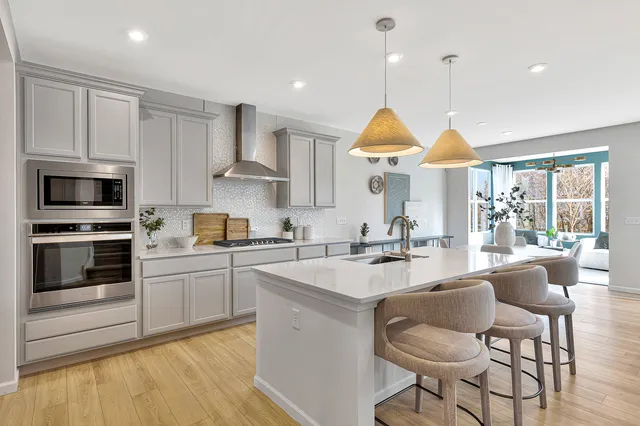 a kitchen with stainless steel appliances granite countertop a stove a sink and a refrigerator