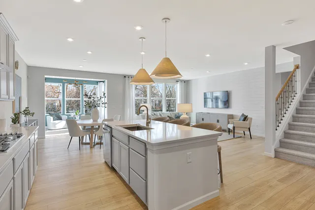 a living room with furniture a table and chairs