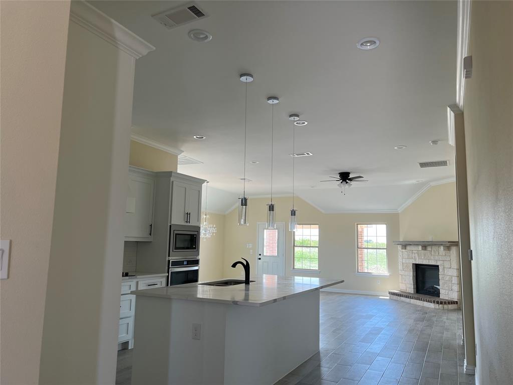 8008 County Road 1058 Rice, TX 75155 - Photo 6 of 25 Open concept living area with vaulted ceiling and crown molding