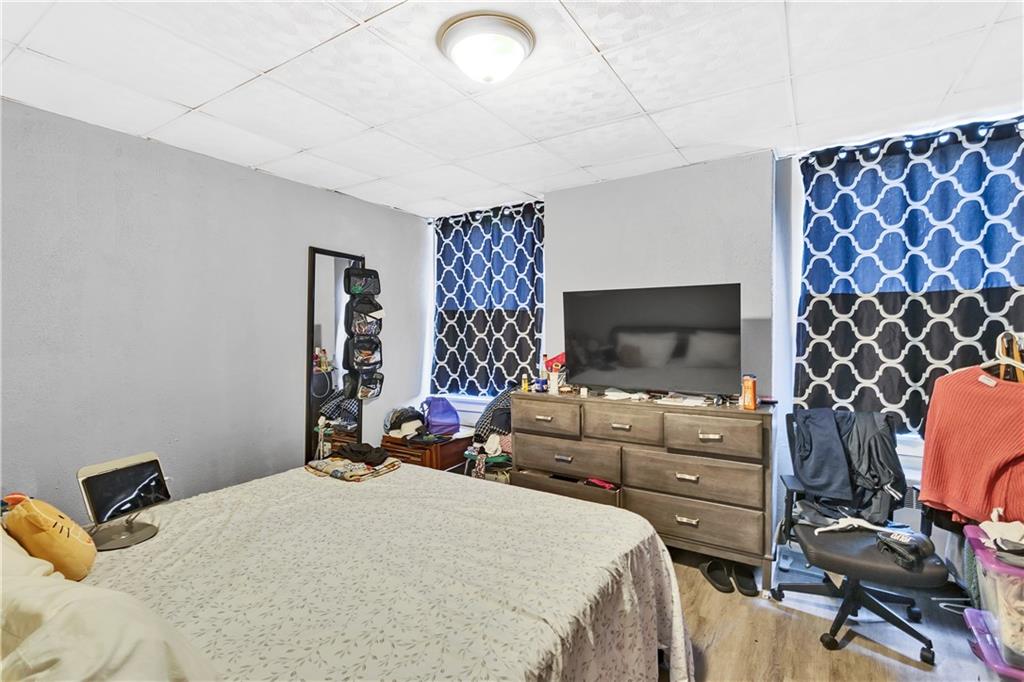 810 Amity Street Homestead, PA 15120 - Photo 15 of 32 a bedroom with bed and a flat screen tv