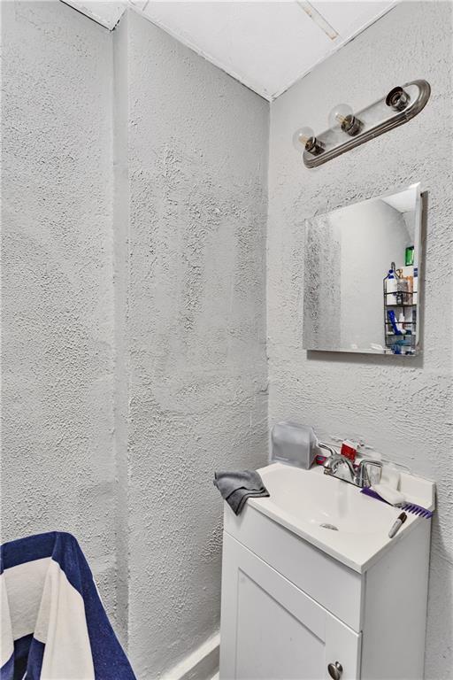 810 Amity Street Homestead, PA 15120 - Photo 19 of 32 a bathroom with a sink toilet and vanity
