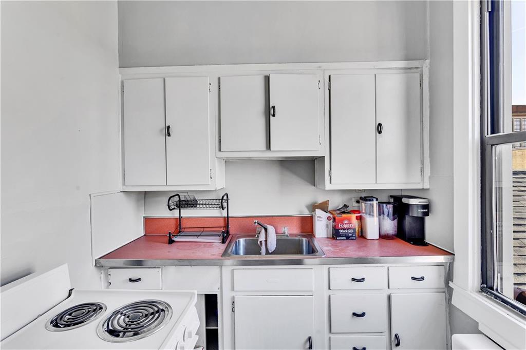 810 Amity Street Homestead, PA 15120 - Photo 21 of 32 a kitchen with a stove and cabinets