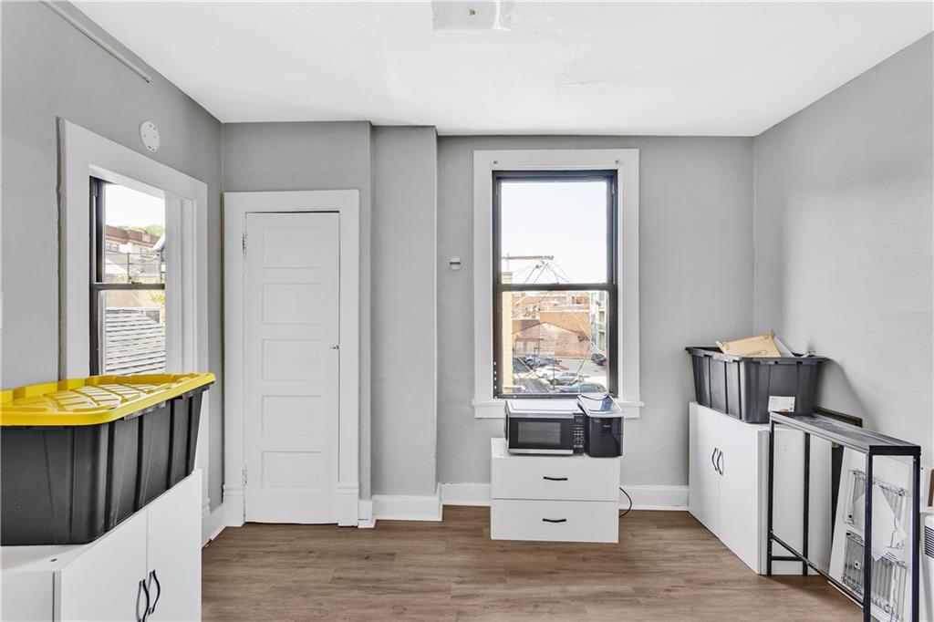 810 Amity Street Homestead, PA 15120 - Photo 23 of 32 a view of a bedroom with wooden floor and windows