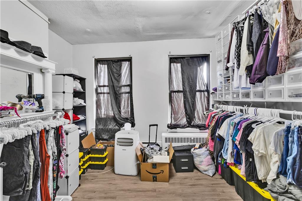 810 Amity Street Homestead, PA 15120 - Photo 28 of 32 a view of walk in closet with clothes