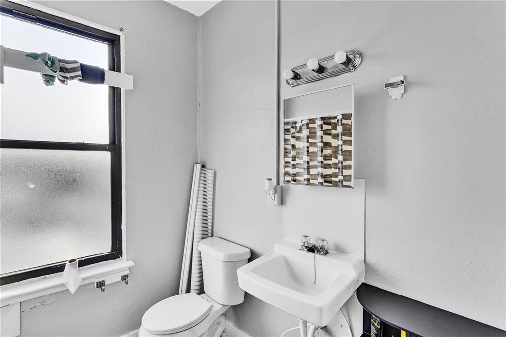 810 Amity Street Homestead, PA 15120 - Photo 29 of 32 a bathroom with a sink toilet and shower