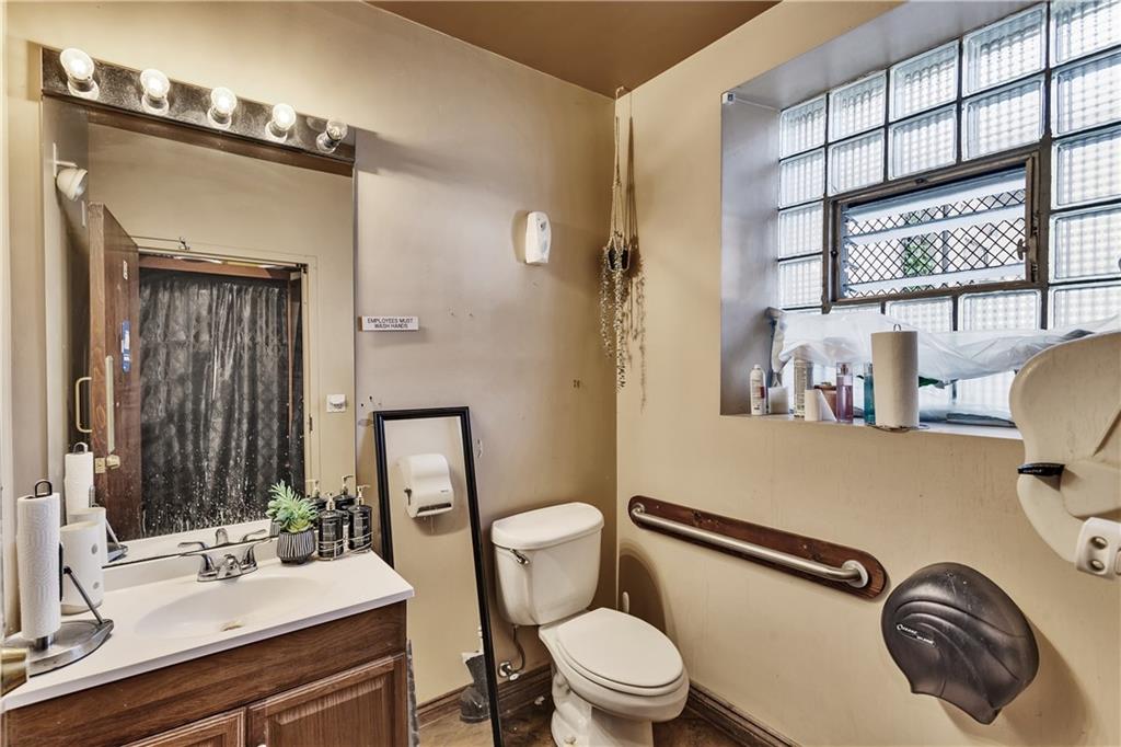 810 Amity Street Homestead, PA 15120 - Photo 10 of 32 a bathroom with a sink mirror vanity and toilet