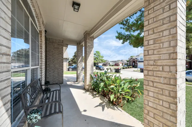 a view of a porch with chairs and backyard
