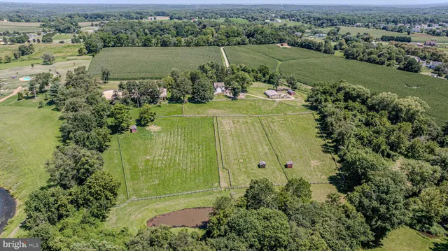 a view of a yard with wooden fence