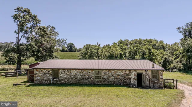 a backyard of a house with barbeque oven and a table and chairs