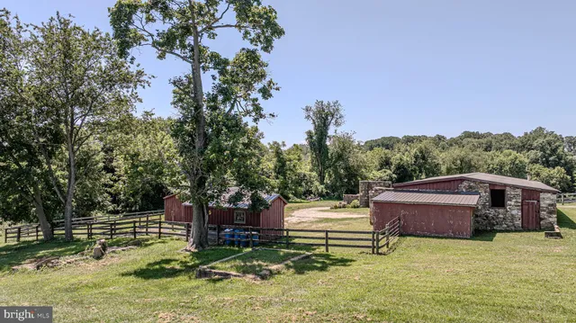 a view of a house with a yard and a pond