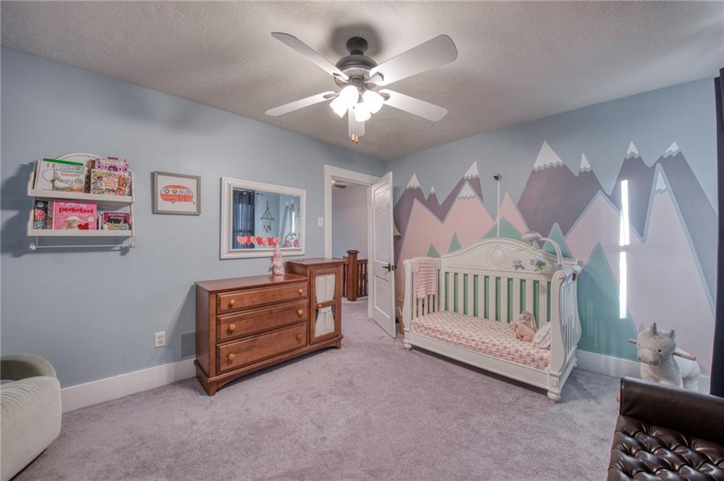 1129 Atlantic Avenue Monaca, PA 15061 - Photo 14 of 37 a spacious bedroom with a bed and a chandelier