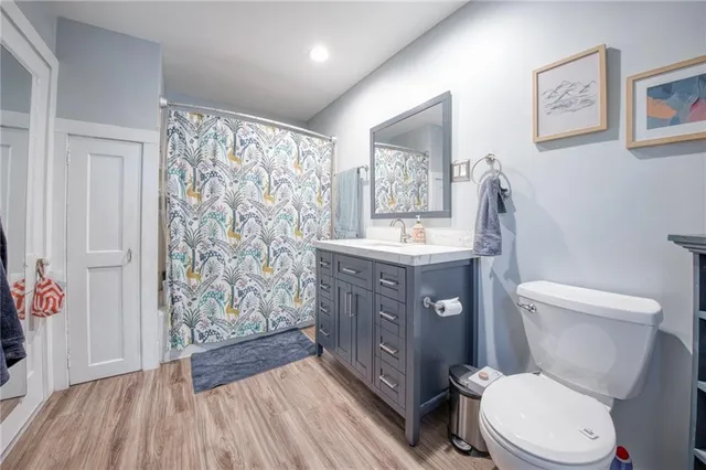 a bathroom with a toilet a sink and mirror