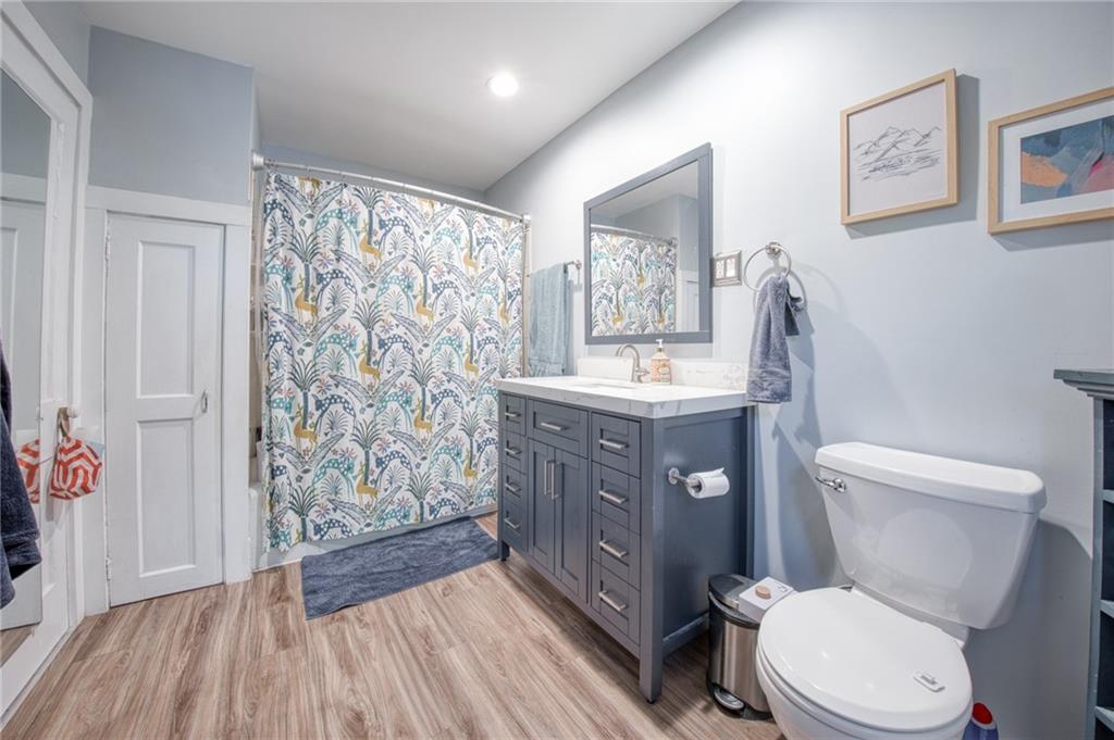 1129 Atlantic Avenue Monaca, PA 15061 - Photo 17 of 37 a bathroom with a toilet a sink and mirror