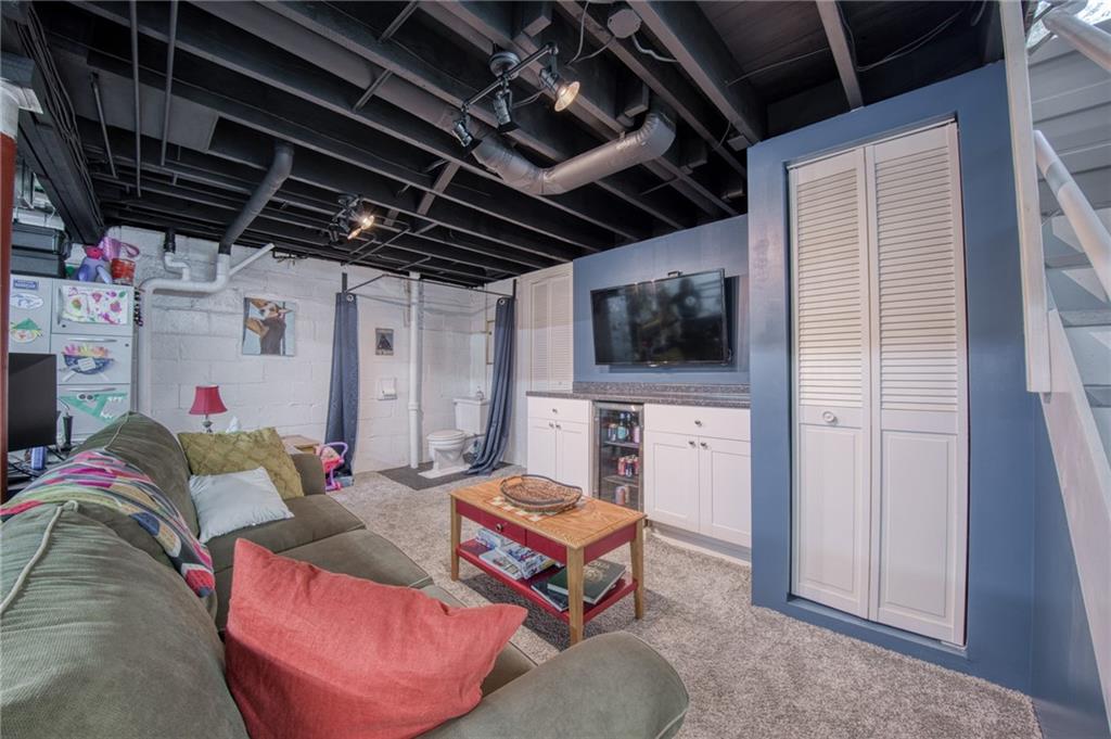 1129 Atlantic Avenue Monaca, PA 15061 - Photo 20 of 37 a living room with furniture and a flat screen tv