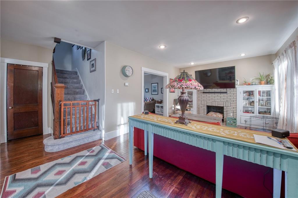 1129 Atlantic Avenue Monaca, PA 15061 - Photo 2 of 37 a room with furniture a flat screen tv and a fireplace