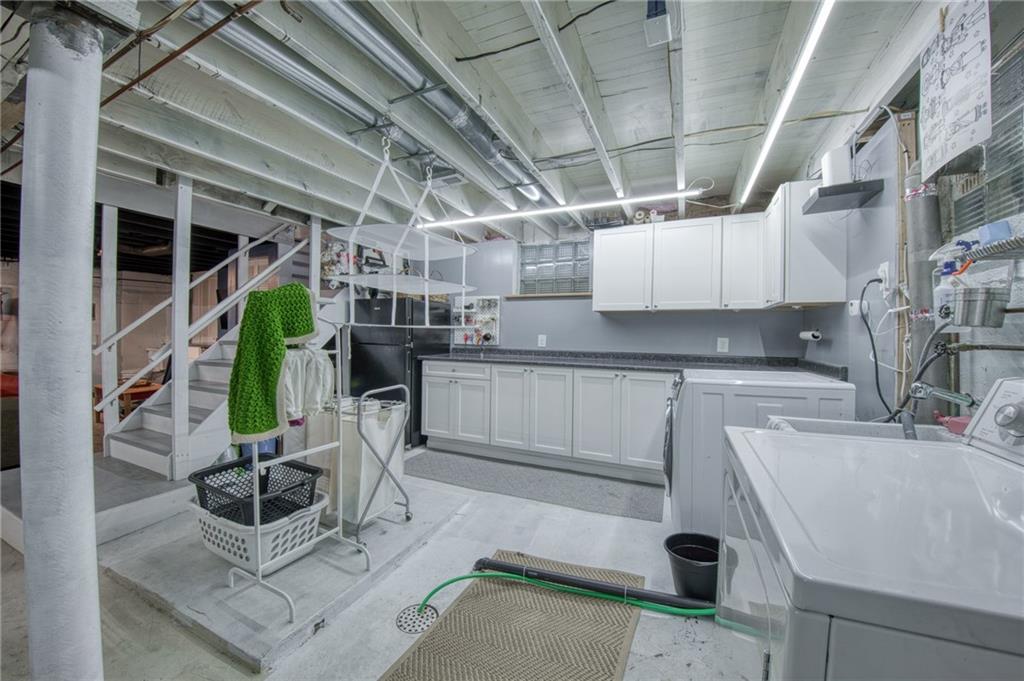 1129 Atlantic Avenue Monaca, PA 15061 - Photo 22 of 37 a kitchen with cabinets and chairs
