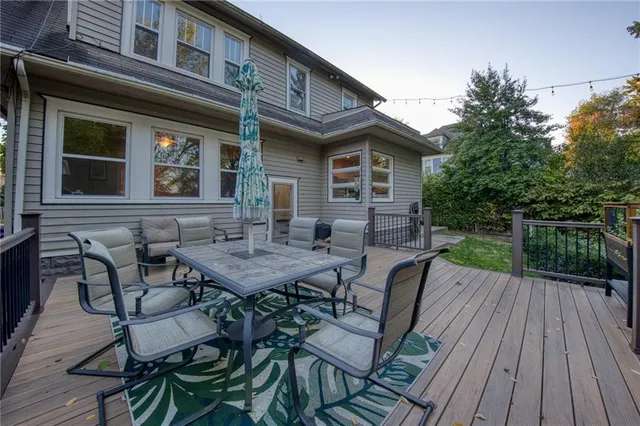 a view of house with backyard and sitting area