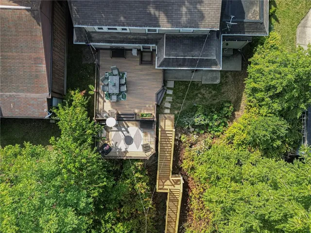 aerial view of a house with a yard and plants
