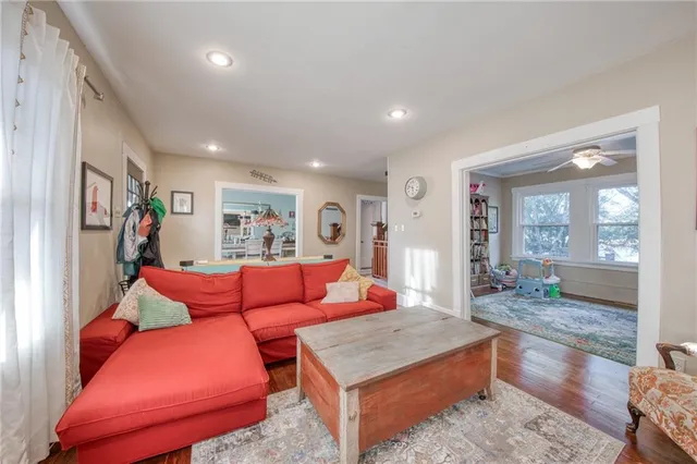 a living room with furniture a rug and a large window