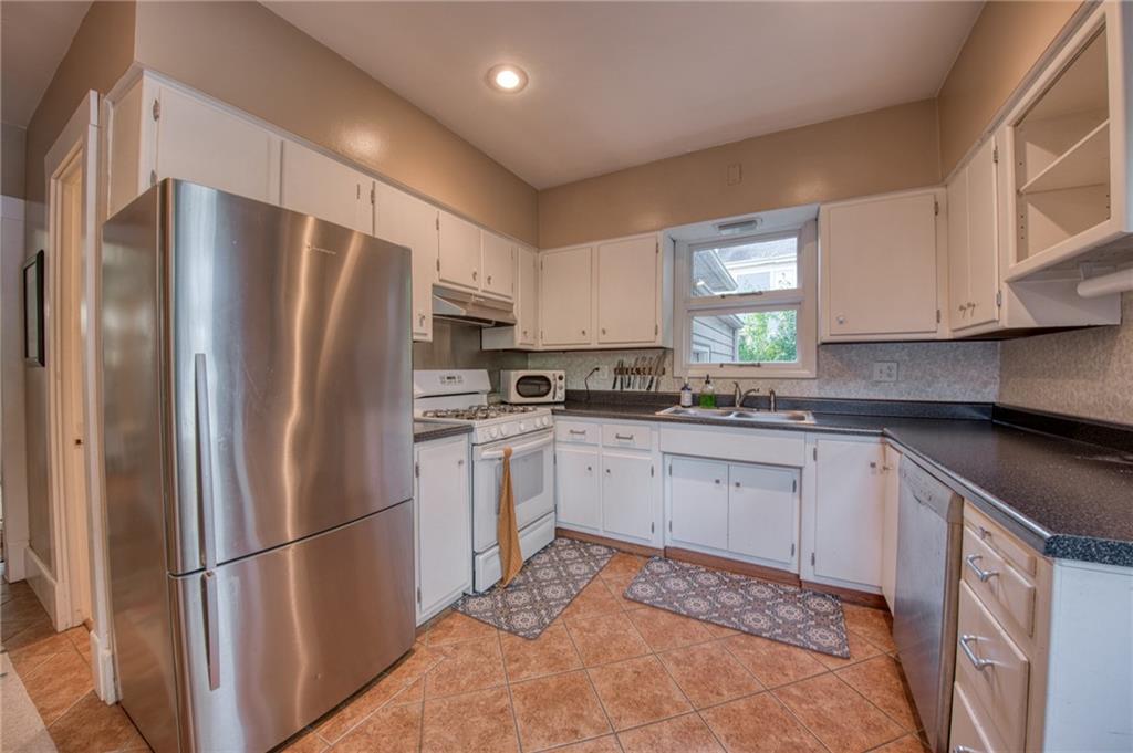 1129 Atlantic Avenue Monaca, PA 15061 - Photo 10 of 37 a kitchen with stainless steel appliances granite countertop a refrigerator sink and stove