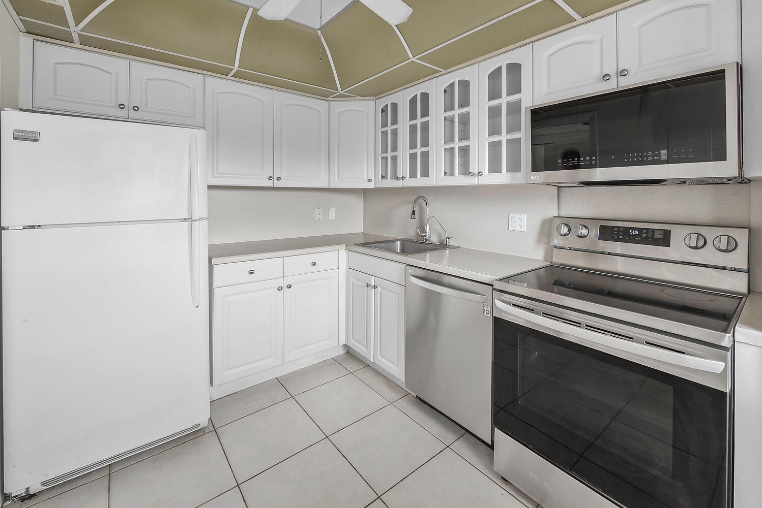2871 North Ocean Boulevard, Unit F429 Boca Raton, FL 33431 - Photo 11 of 38 a kitchen with cabinets stainless steel appliances and a sink