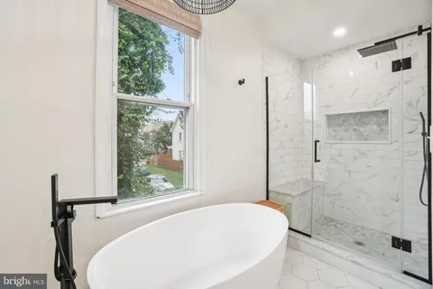 a bathroom with a bathtub and shower