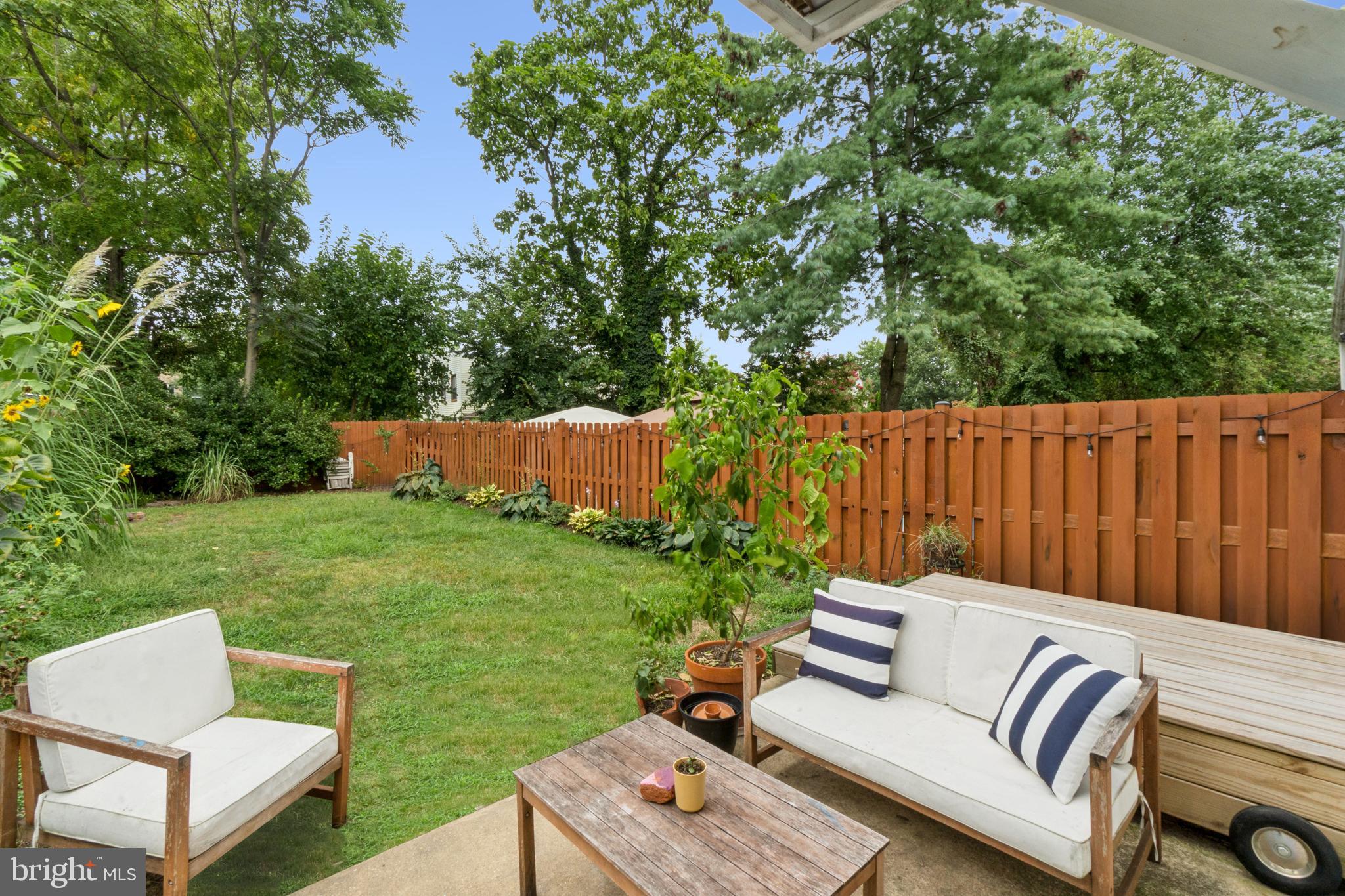 3206 5th Street Southeast Washington, DC 20032 - Photo 22 of 25 an outdoor sitting area with couch and a garden